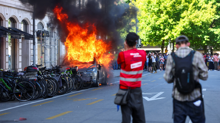 Anti-G7 protest turns violent as demonstrators torch Tesla and smash UN office windows